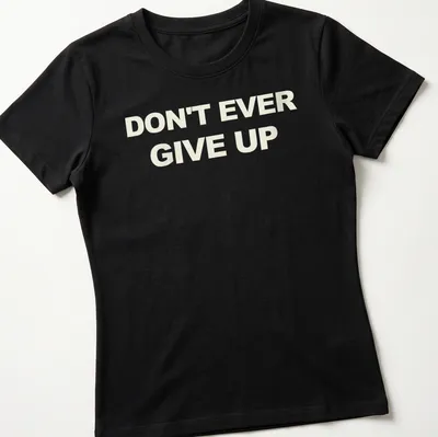 Bold typography t-shirt with the motivational phrase Don't Ever Give Up in white. — printed on a women's shirt