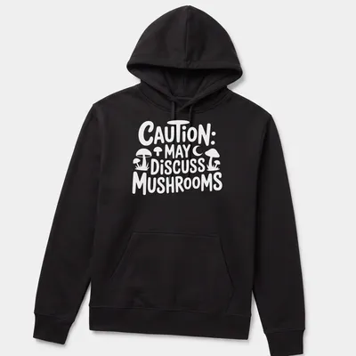 Playful typography shirt with 'Caution May Discuss Mushrooms' and whimsical mushroom illustrations — printed on a unisex hoodie
