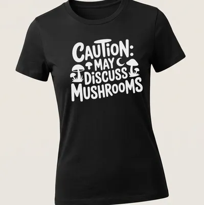 Playful typography shirt with 'Caution May Discuss Mushrooms' and whimsical mushroom illustrations — printed on a women's shirt
