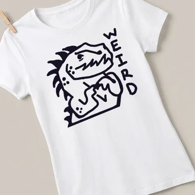 Bold line-art Nervous Dinosaur with the word WEIRD above it in black and white — printed on a women's shirt