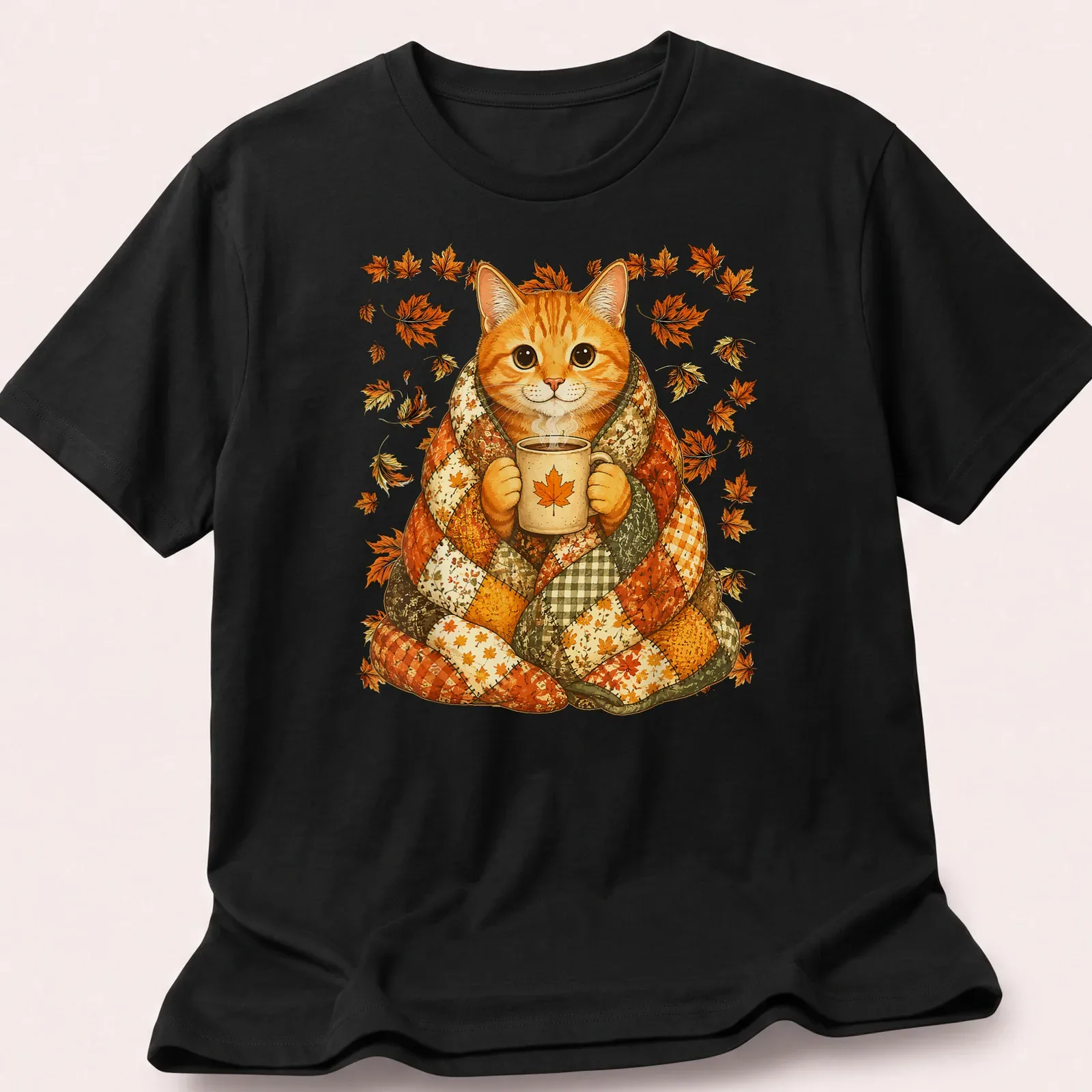 Illustrative t-shirt featuring an orange tabby cat surrounded by colorful maple leaves. — printed on a unisex t-shirt