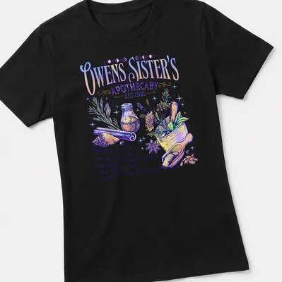 Whimsical illustration of herbs and spices with colorful text about luck and love — printed on a women's shirt