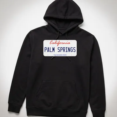 Vintage license plate design featuring Palm Springs, California, in red, blue, and white. — printed on a unisex hoodie