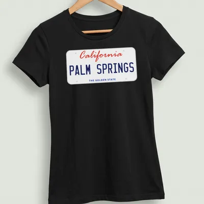 Vintage license plate design featuring Palm Springs, California, in red, blue, and white. — printed on a women's shirt
