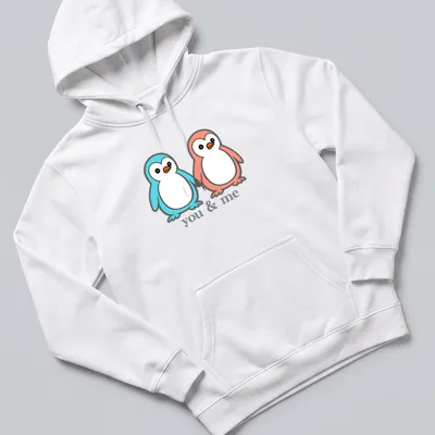 Kawaii design of two penguins holding flippers with 'you & me' text — printed on a unisex hoodie
