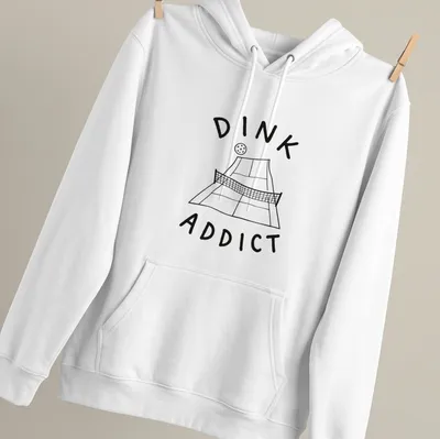 Line-art pickleball court with bold text 'DINK ADDICT' in black and white — printed on a unisex hoodie