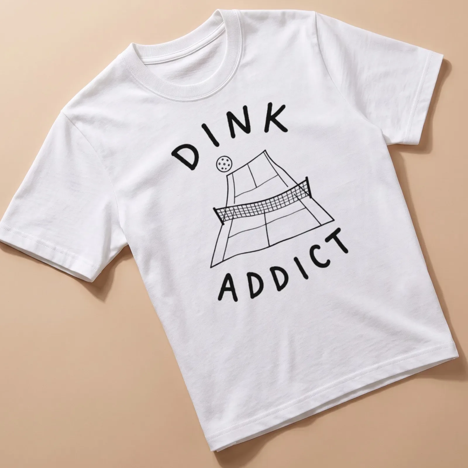 Line-art pickleball court with bold text 'DINK ADDICT' in black and white — printed on a unisex t-shirt