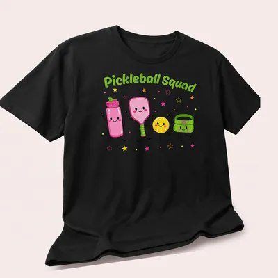 Cartoon pickleball characters with vibrant colors and humorous design — printed on a unisex t-shirt (angled view)