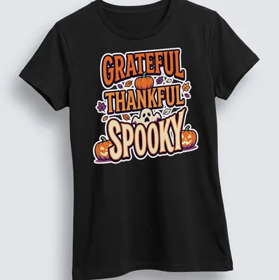 Playful cartoon graphic of pumpkins with 'GRATEFUL THANKFUL SPOOKY' text — printed on a women's shirt