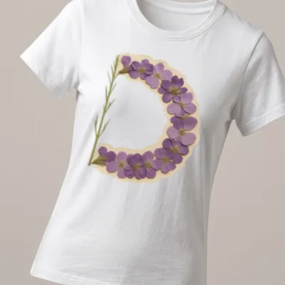 Vintage pressed T-shirt featuring a floral letter D in purple, green, and beige — printed on a women's shirt