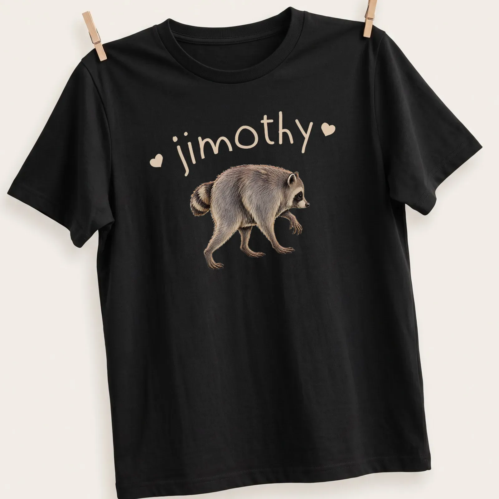 Realistic raccoon illustration with the name 'jimothy' printed above in bold text — printed on a unisex t-shirt