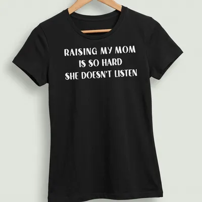 Bold text t-shirt reading 'Raising My Mom Is So Hard She Doesn't Listen' in white. — printed on a women's shirt