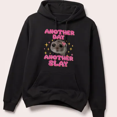 Kawaii design of a sad hamster with the text Another Day Another Slay in bright colors — printed on a unisex hoodie