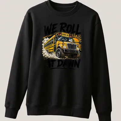Bold graphic t-shirt featuring a school bus and the phrase We Roll At Dawn — printed on a unisex sweatshirt