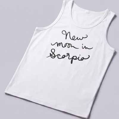 Black shirt with handwritten text 'New moon in Scorpio' in elegant script. — printed on a tank top