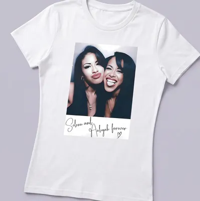 Vintage tribute t-shirt featuring Selena and Aaliyah with nostalgic text — printed on a women's shirt