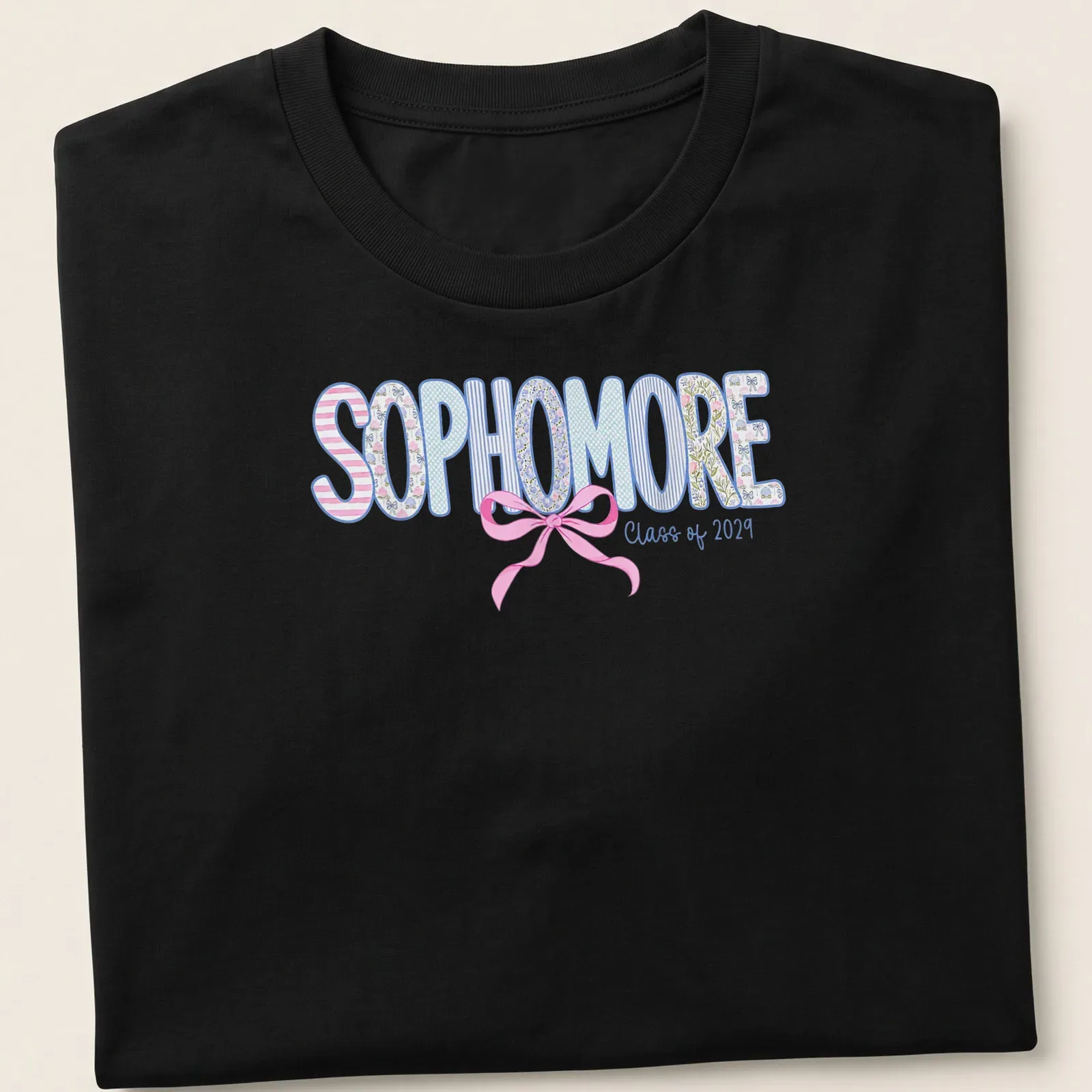 Playful floral design featuring a Coquette Bow with the text 'SOPHOMORE Class of 2029' — printed on a unisex t-shirt