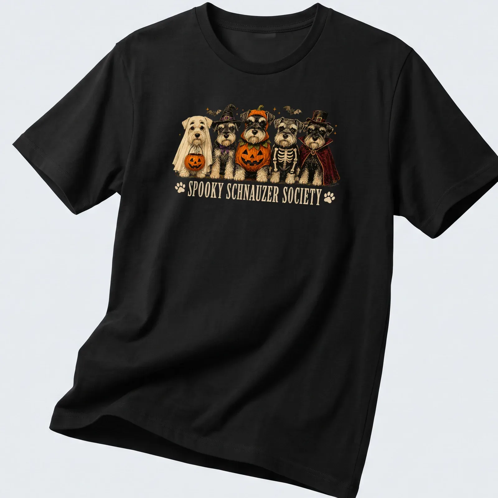 Whimsical illustration of Schnauzer dogs in Halloween skeleton costumes with colorful text above — printed on a unisex t-shirt