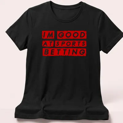 Bold graphic t-shirt featuring the phrase 'I'm Good At Sports Betting' in red and white — printed on a women's shirt