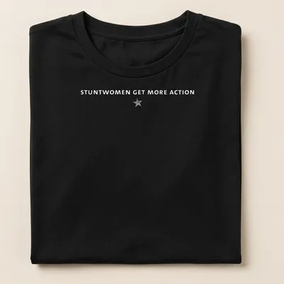 Bold typography t-shirt featuring the text 'Stuntwomen Get More Action' in white and gray — printed on a women's shirt