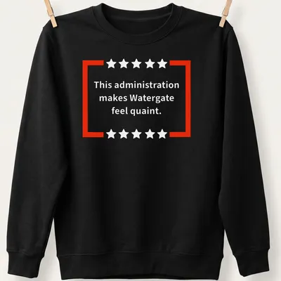 Red and white t-shirt featuring bold text of a political commentary — printed on a unisex sweatshirt