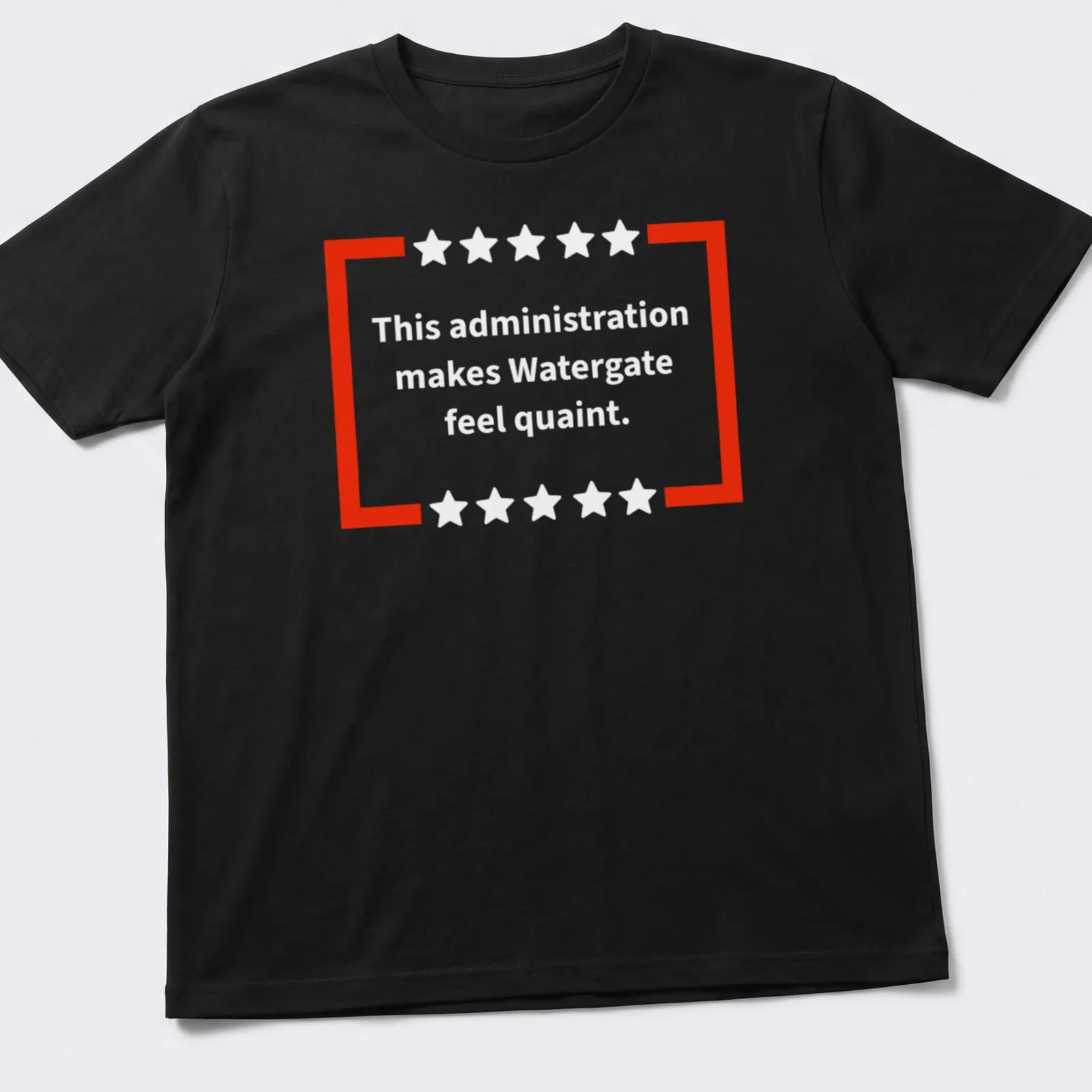Red and white t-shirt featuring bold text of a political commentary — printed on a unisex t-shirt