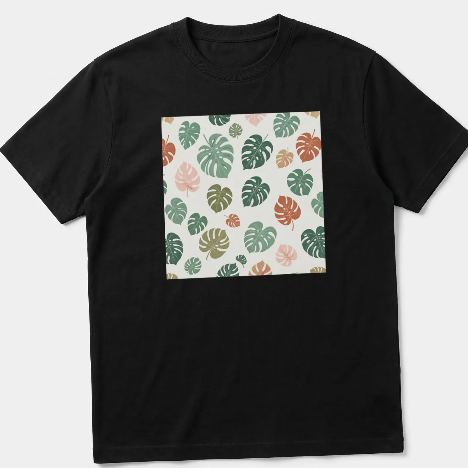 Botanical pattern T-shirt featuring tropical Monstera leaves in various colors — printed on a unisex t-shirt