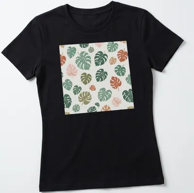 Botanical pattern T-shirt featuring tropical Monstera leaves in various colors — printed on a women's shirt
