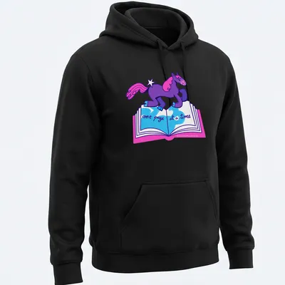 Colorful cartoon unicorn with text 'one page at a time' in purple, pink, and blue — printed on a unisex hoodie