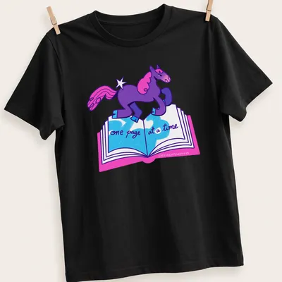 Colorful cartoon unicorn with text 'one page at a time' in purple, pink, and blue