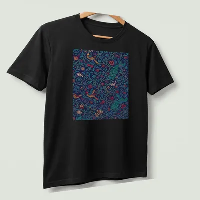 Vintage abstract floral design featuring birds in teal, navy, red, yellow, and green. — printed on a unisex t-shirt (angled view)