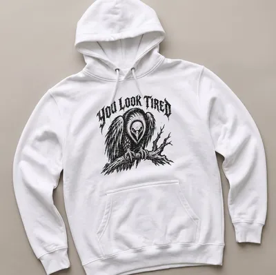 Vintage distressed t-shirt featuring a cartoon vulture and the phrase 'YOU LOOK TIRED' — printed on a unisex hoodie