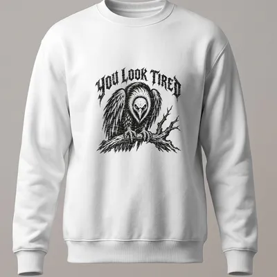 Vintage distressed t-shirt featuring a cartoon vulture and the phrase 'YOU LOOK TIRED' — printed on a unisex sweatshirt