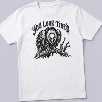 Vintage distressed t-shirt featuring a cartoon vulture and the phrase 'YOU LOOK TIRED'