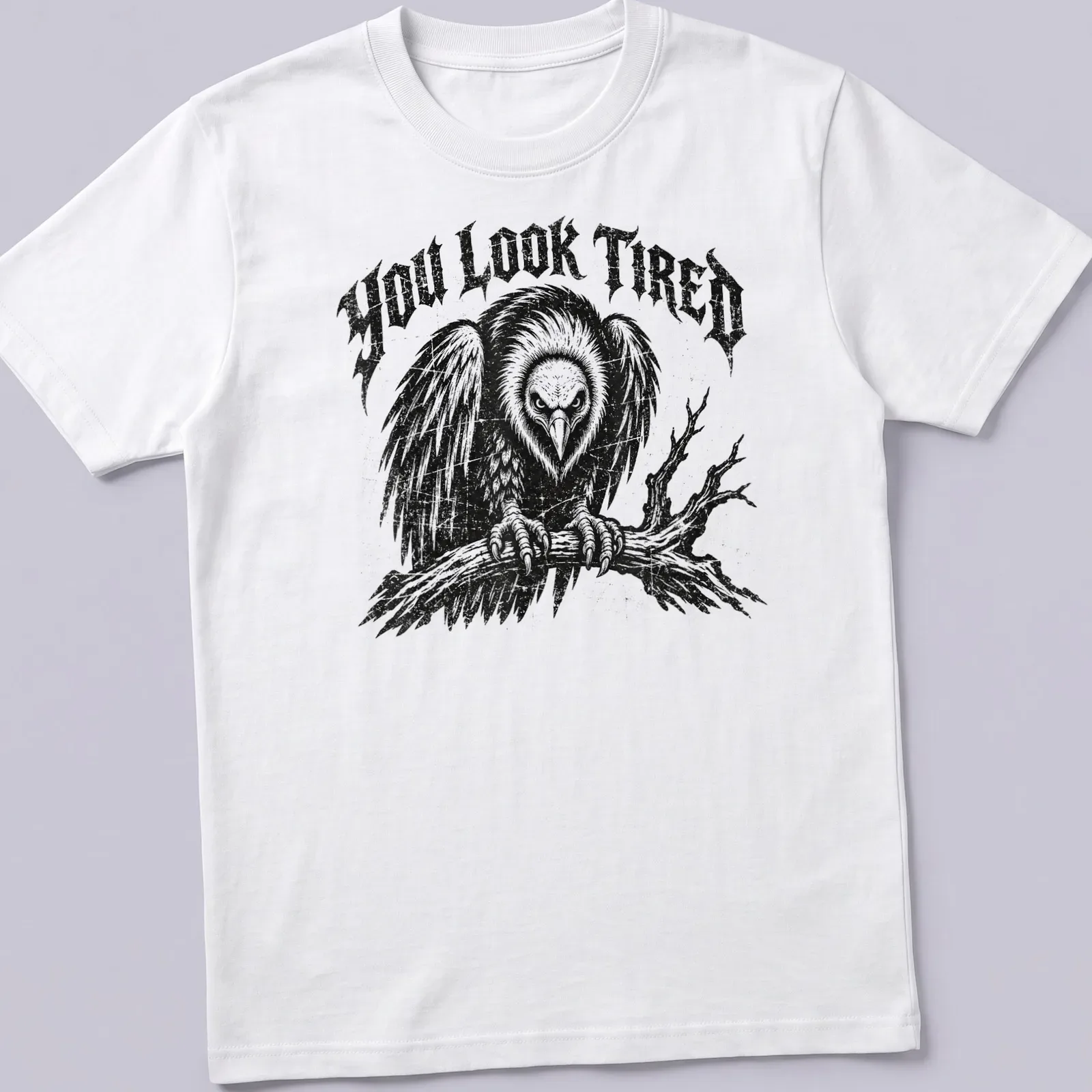 Vintage distressed t-shirt featuring a cartoon vulture and the phrase 'YOU LOOK TIRED' — printed on a unisex t-shirt