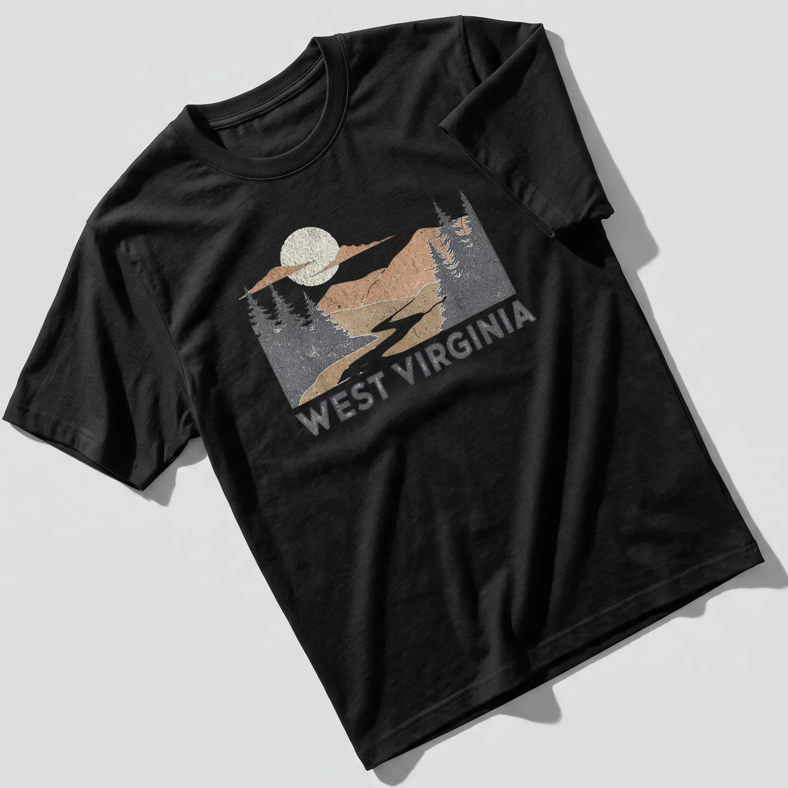 Vintage distressed West Virginia T-shirt with mountains and river scene — printed on a unisex t-shirt