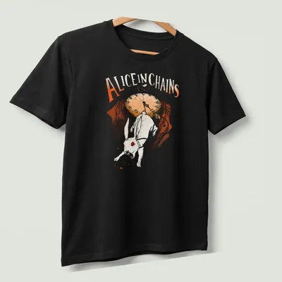 Whimsical illustration of a white rabbit with text 'Alice In Chains' in orange and brown — printed on a unisex t-shirt (angled view)