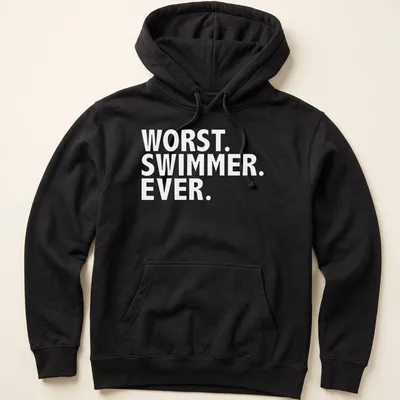 Playful cartoon of a swimmer with text 'Worst Swimmer Ever' in blue, yellow, and white — printed on a unisex hoodie
