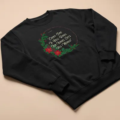 Illustrative T-shirt with a wreath, flowers, and the quote about angels' wings. — printed on a unisex sweatshirt