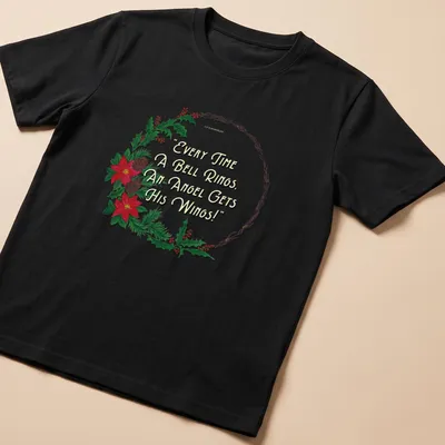 Illustrative T-shirt with a wreath, flowers, and the quote about angels' wings.