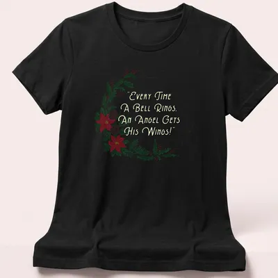 Illustrative T-shirt with a wreath, flowers, and the quote about angels' wings. — printed on a women's shirt